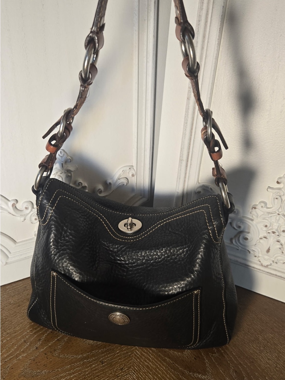 Coach Black Pebbled leather Chelsea turnlock top.